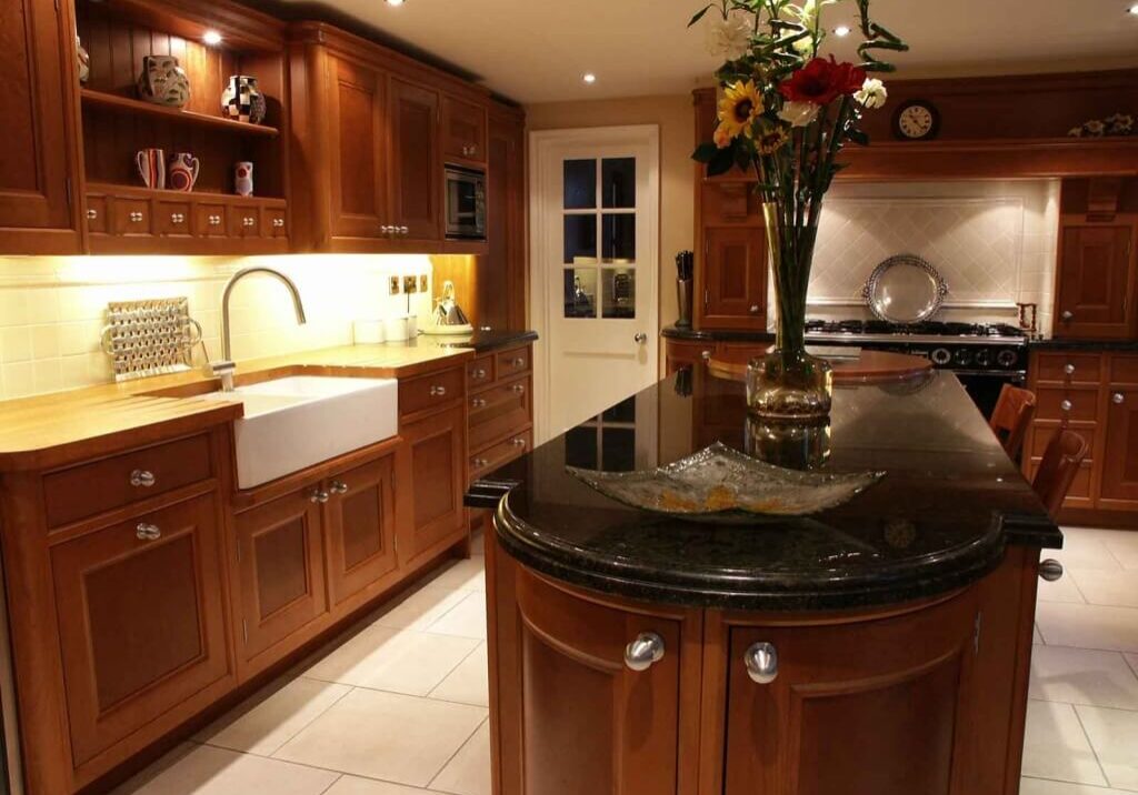 Kitchen remodel with cherry wood cabinetry and curved granite island